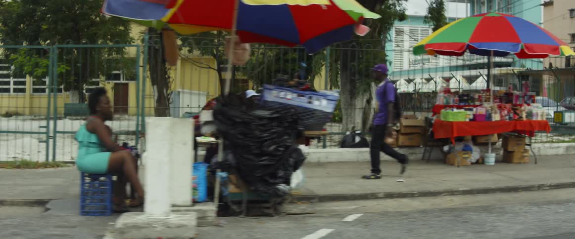 The street is lined with many people and vendors