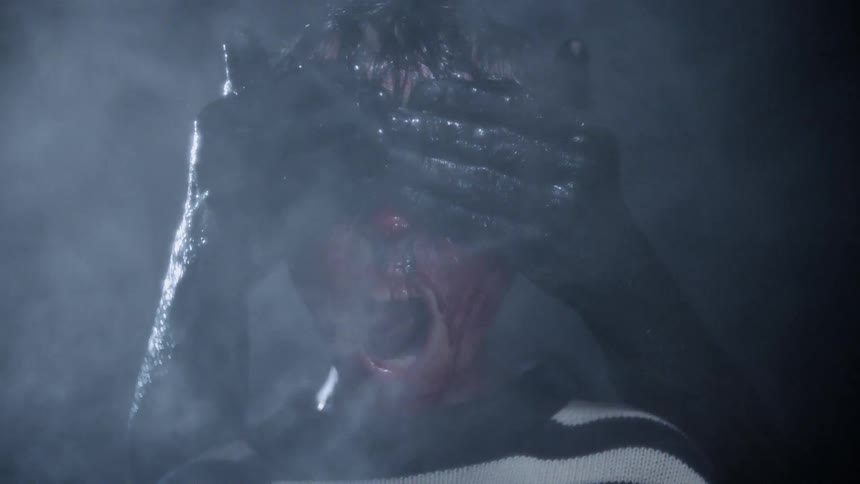 Black slimy hands cover a bleeding child's face
