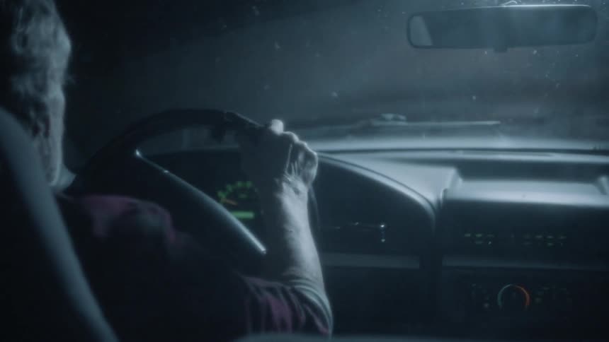 Old Man driving truck down scary road at night
