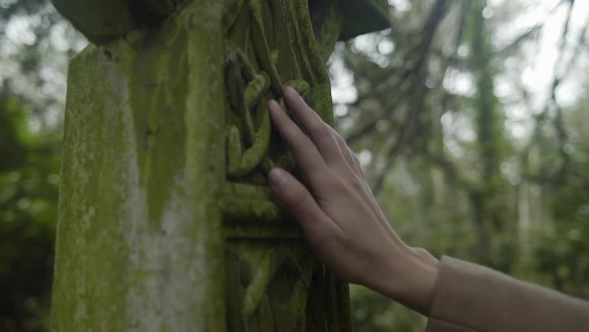 A person is outside touching an object