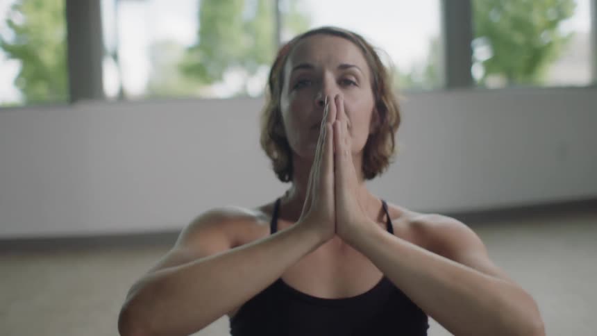 A woman is doing yoga indoors