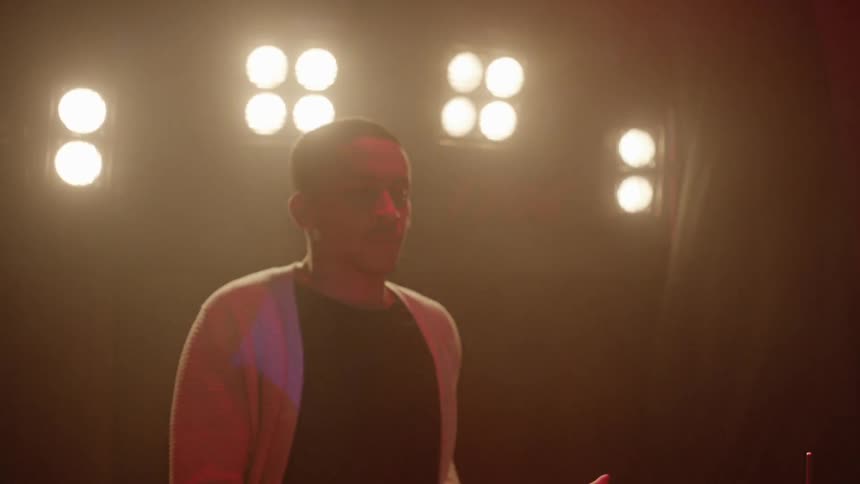 A man is playing the drums on stage