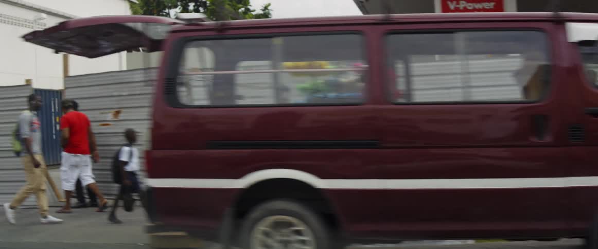 The city street has many people traveling