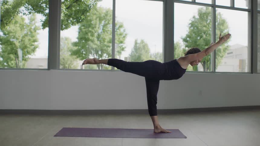 A woman is doing yoga indoors