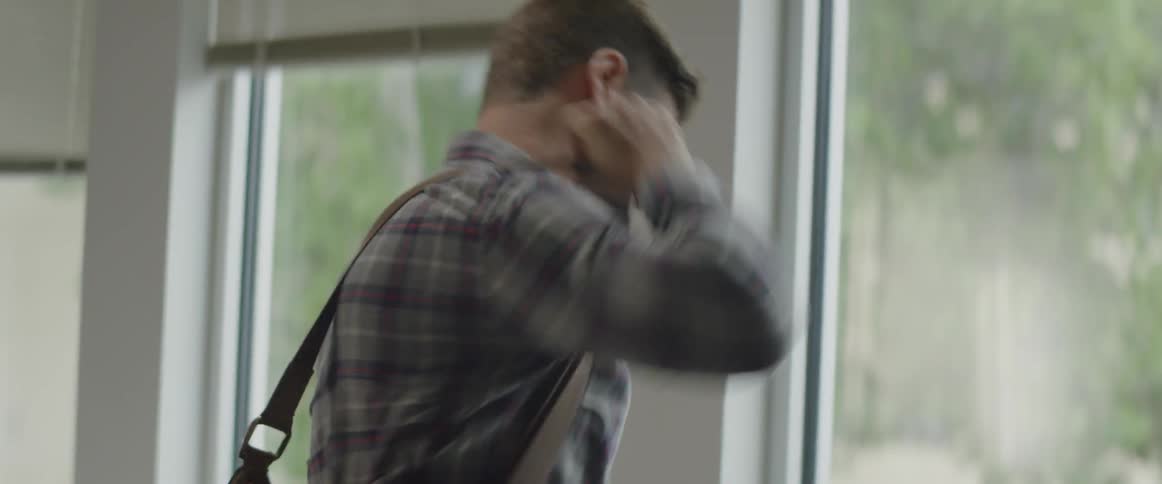 A man is grabbing a bag and walking away