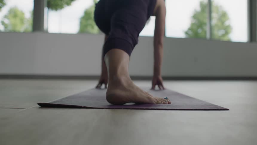 A woman is doing yoga indoors