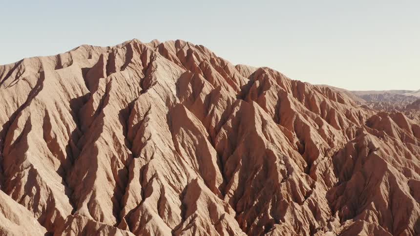 A mountain in a desert on a sunny day
