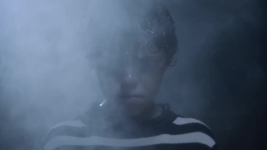 Steam billows around a boy dripping with sweat