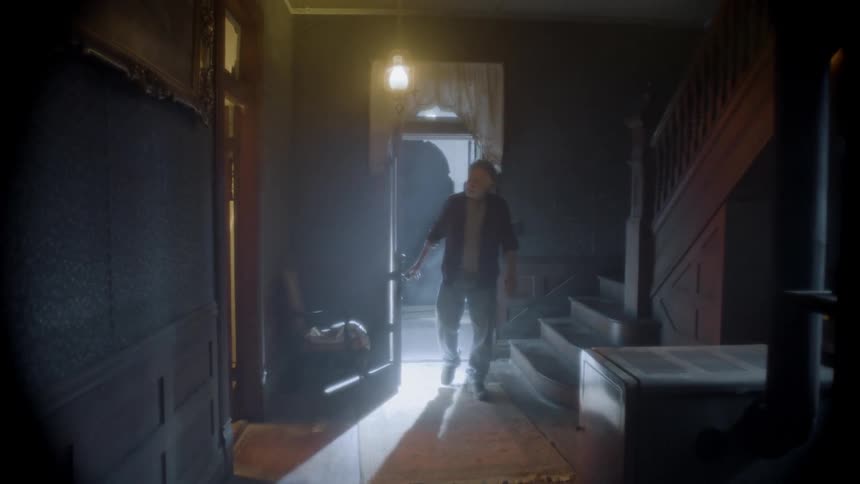 A person walks into a house and looks around
