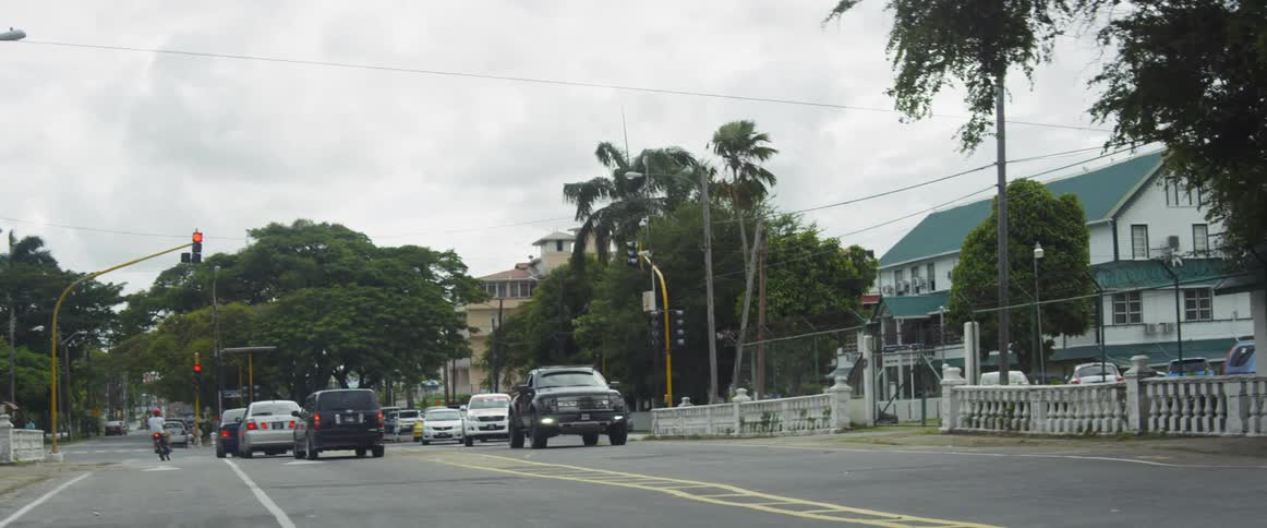 Trucks move along urban street