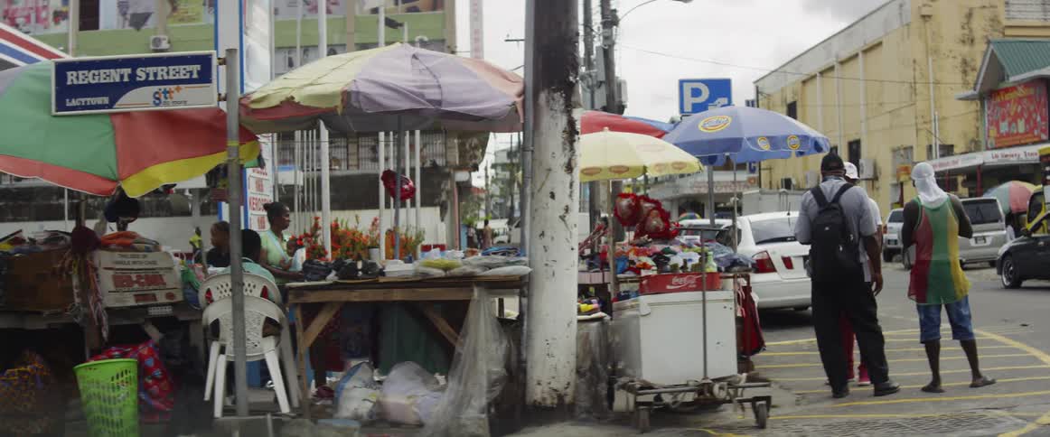 A group of people standing by a street shop