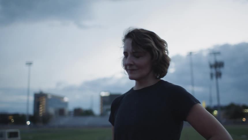 A woman standing at a track