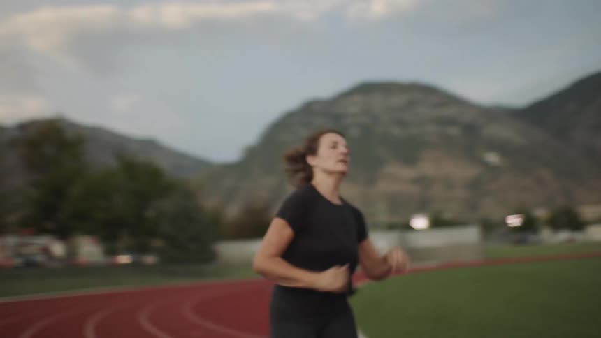 A woman is running on the track