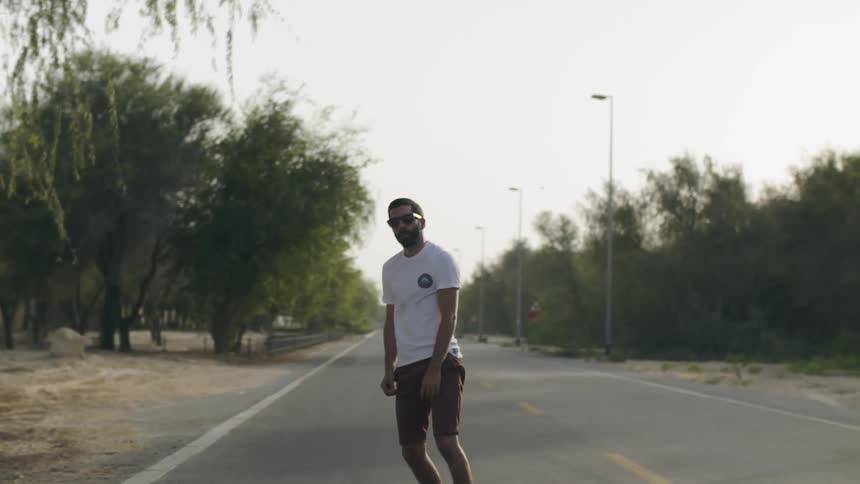 A man skateboarding on the street