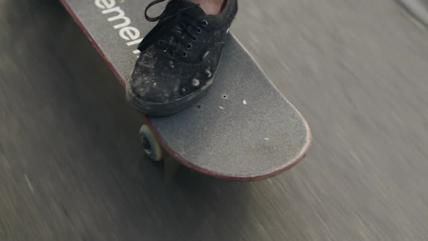 A person is riding their skateboard on a sunny day