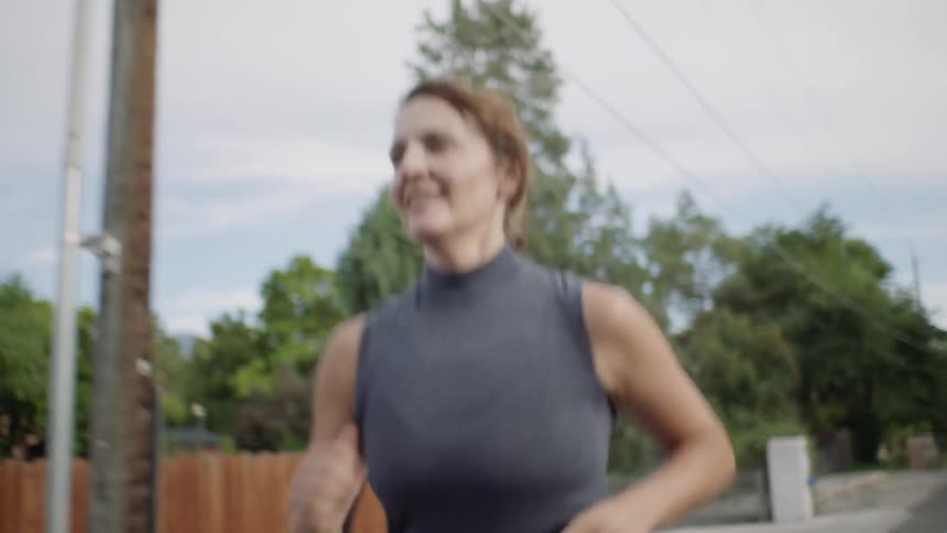 Woman in shorts jogs down the street