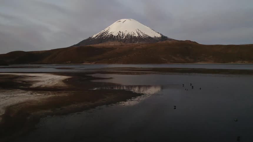 Snow covers the peak of a mountain in the wilderness