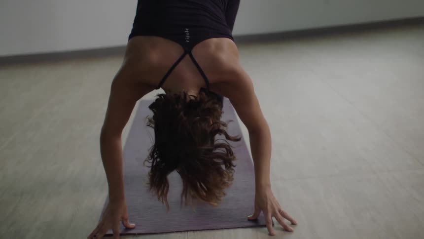 A woman doing yoga on a mat