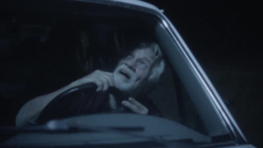 Man looks up at lights while driving in car