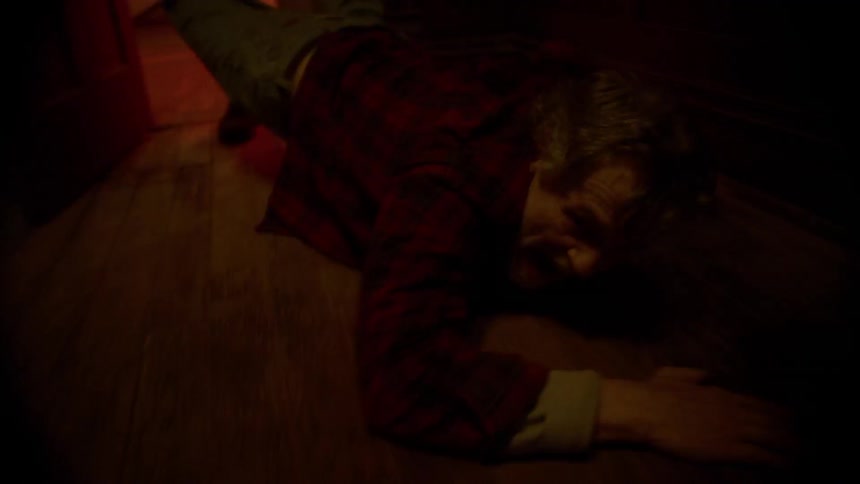 A person is being dragged through a house