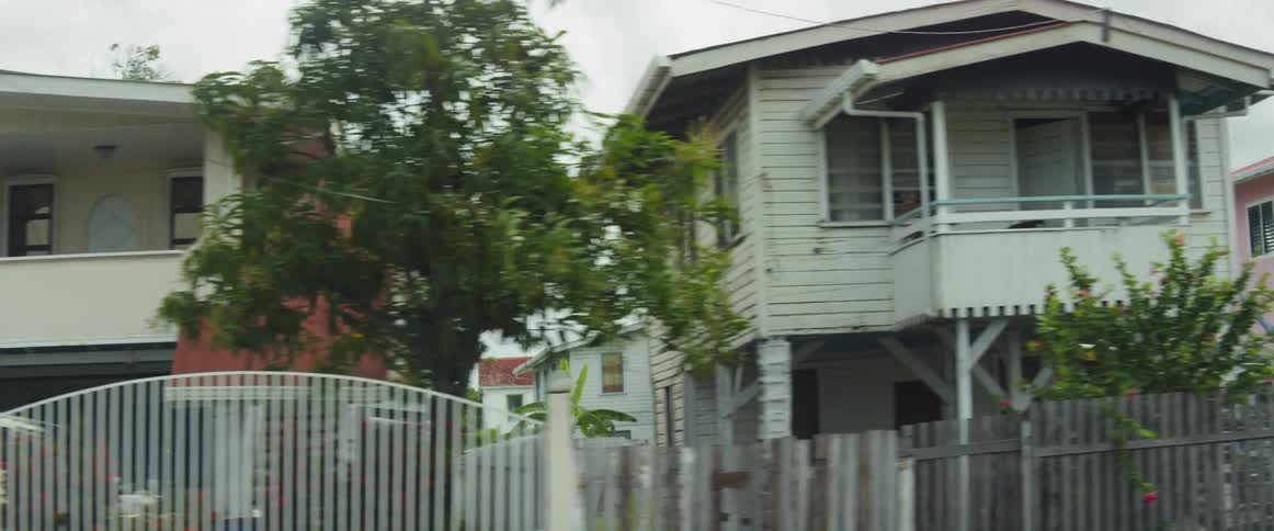 Cars are parked on streets by houses