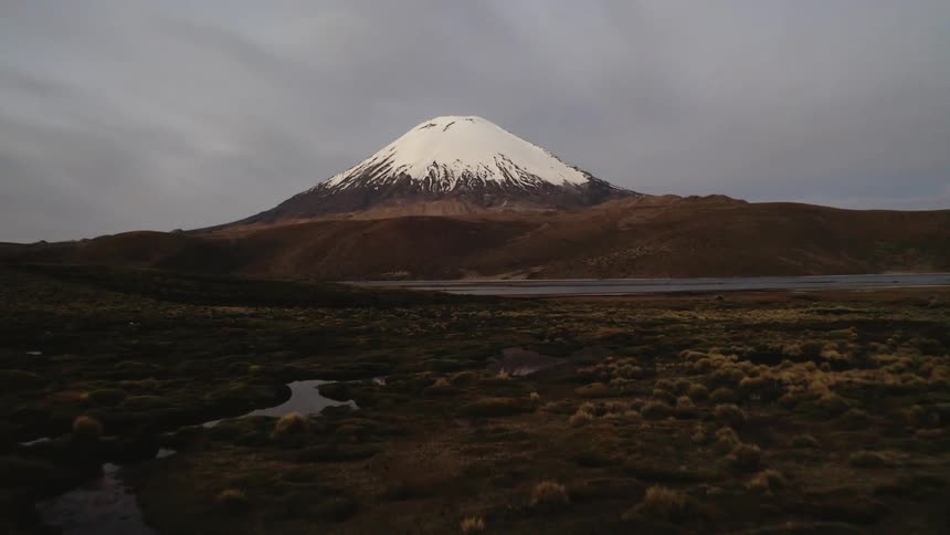 The mountain ahead is covered with snow at the top