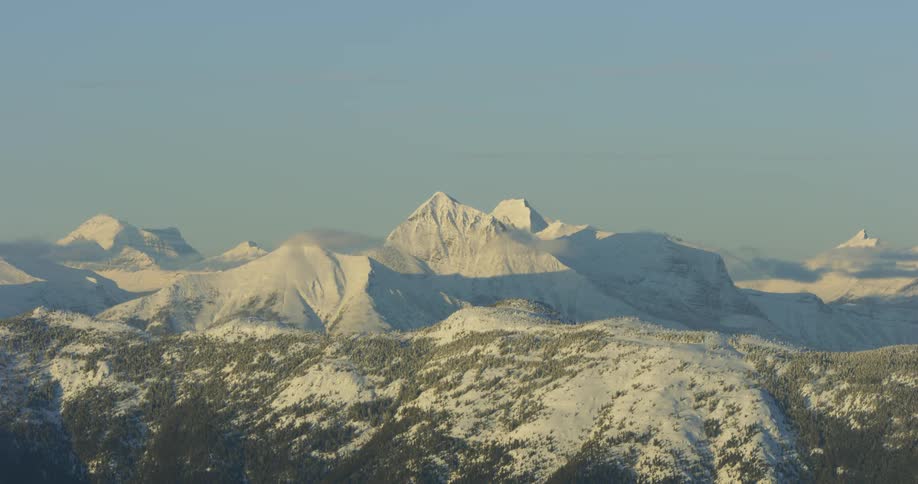 Clouds around a snowy mountain