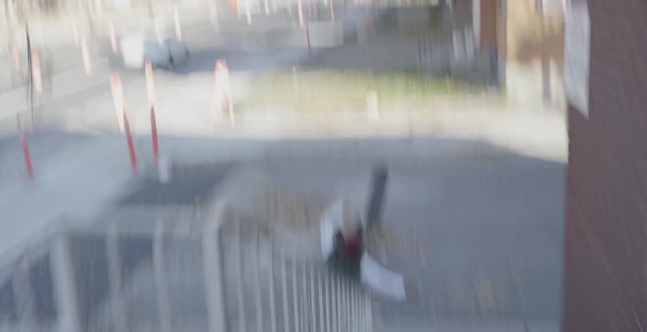 A man falls on his skateboard from a jump and gets up