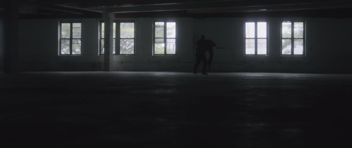A person is indoors with the lights off