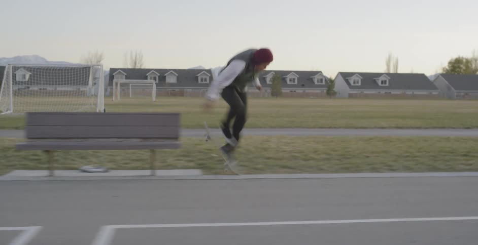 A person tries a stunt on a skateboard and falls