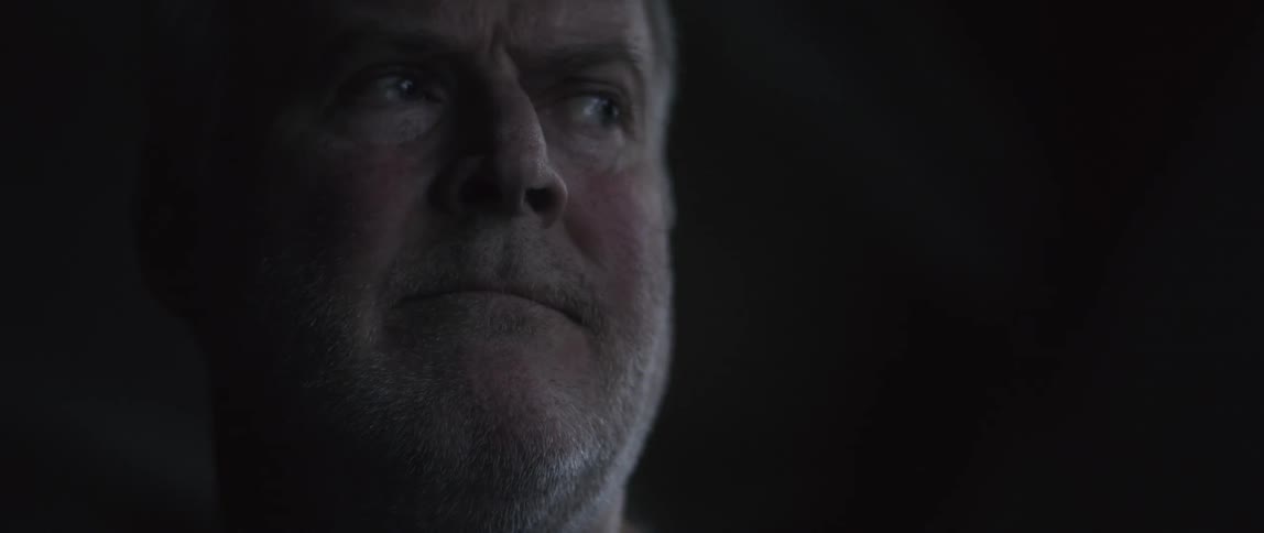 An old man looking up and pinching his lips