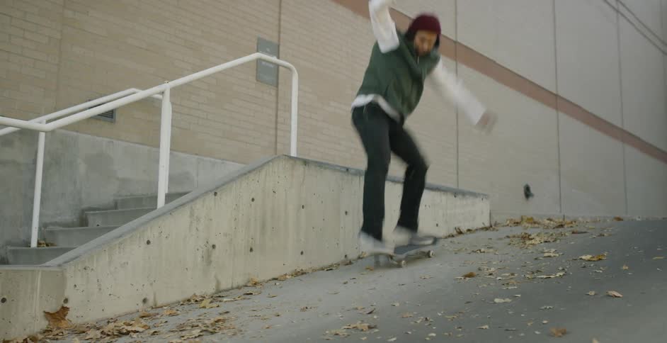A man skateboarding down a ramp and off a stairway