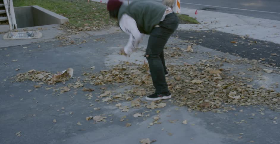 A person is skateboarding down stairs and falls