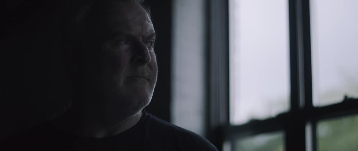 Man turning his head to the side to stare at something off screen
