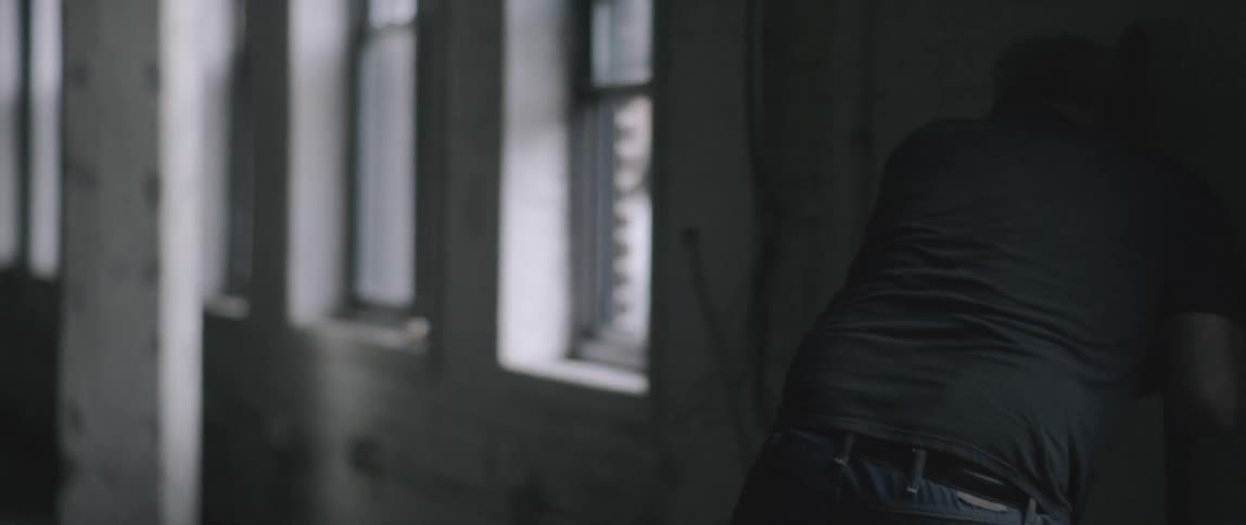 A man runs towards the wall in the building