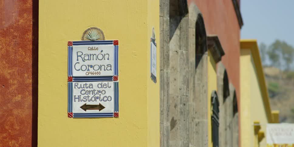 Sign on wall in spanish ("Rom��n Corona Road - Route to the Historic Center")