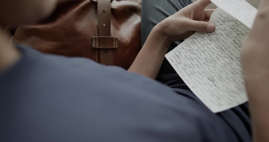 A person reading a letter