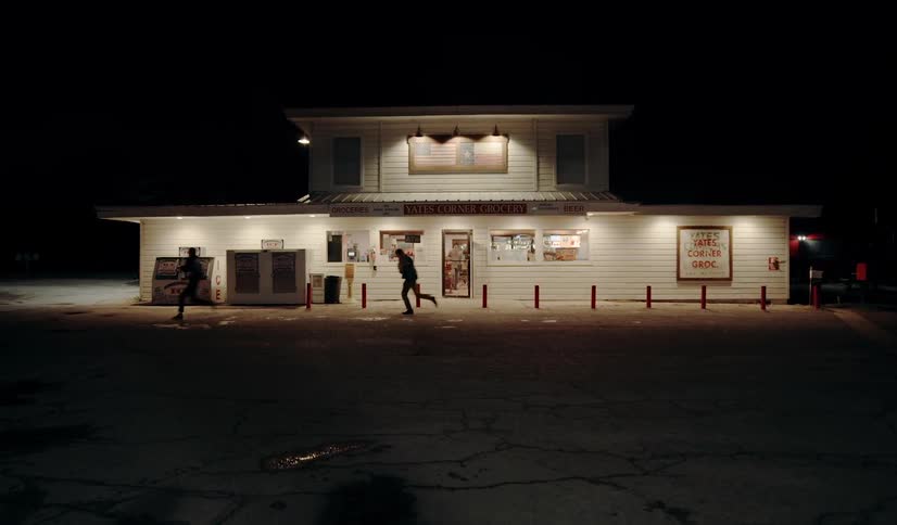 Two  people sprint out of a building
