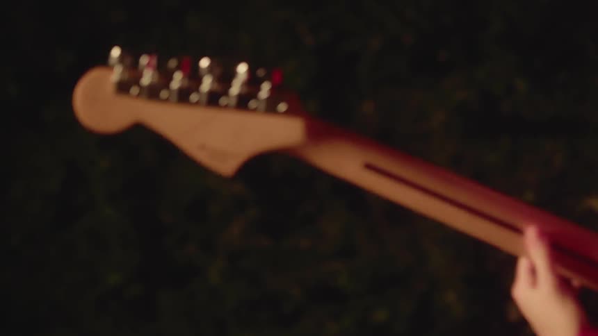 A woman is playing a guitar
