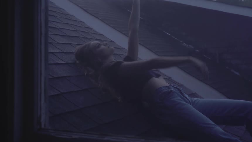 A woman is laying on the roof