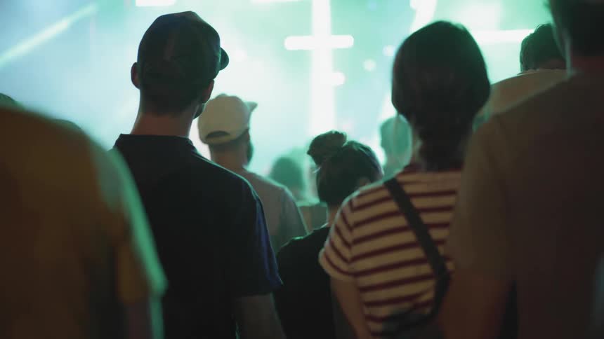 Many people bobbing their heads at a concert