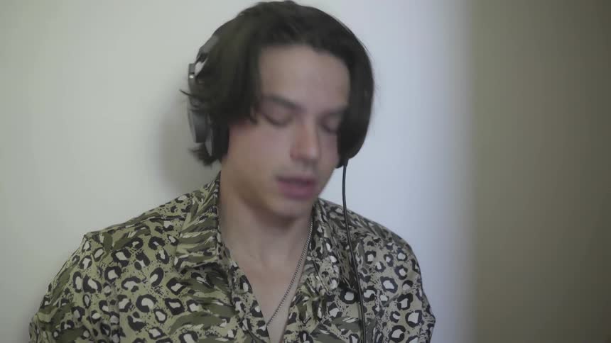 A young man nodding his head while wearing headphones