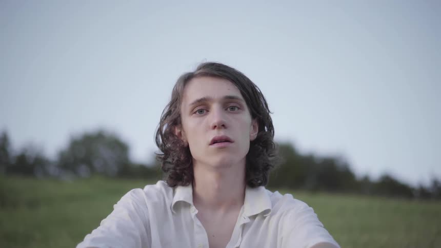A man sits on the grass field
