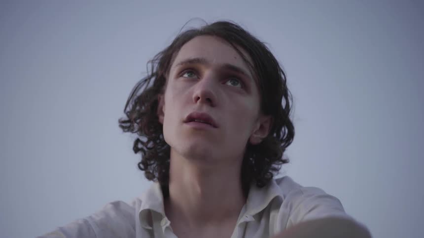 A young person looks into distance and contemplates