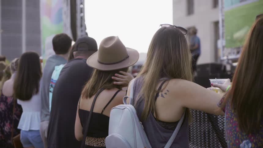 People watch an outdoor concert