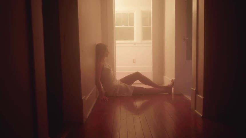 A woman is sitting on the floor of the hall