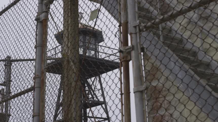 The prison has a watch tower behind the gate