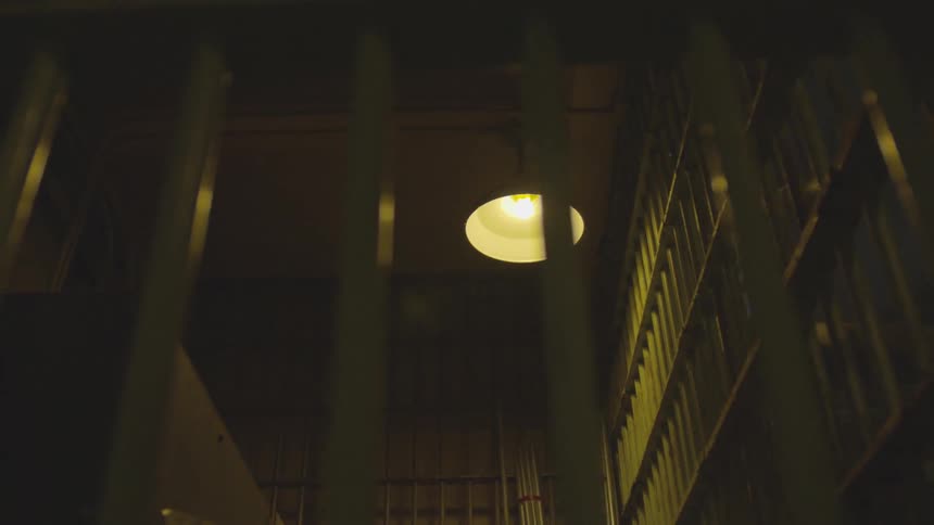 A ceiling light in a prison shines