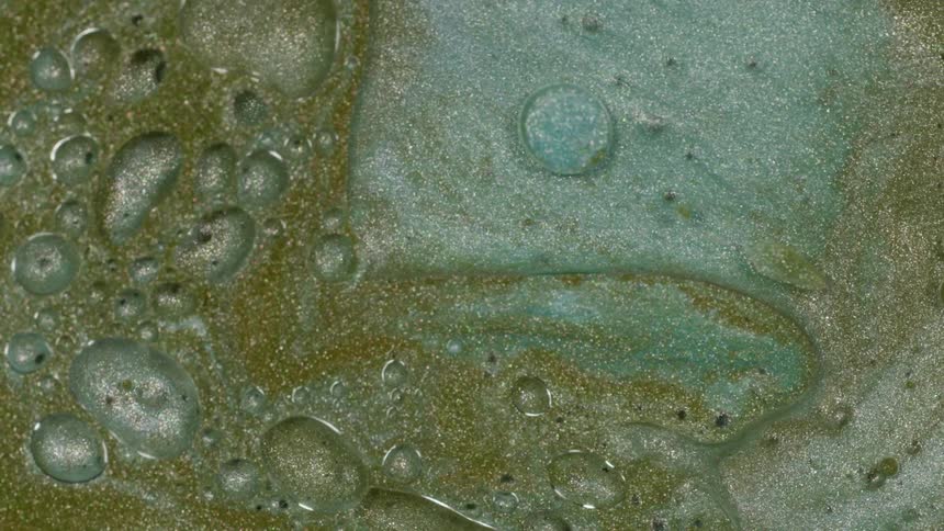 Closeup of water and bubbles moving through sand