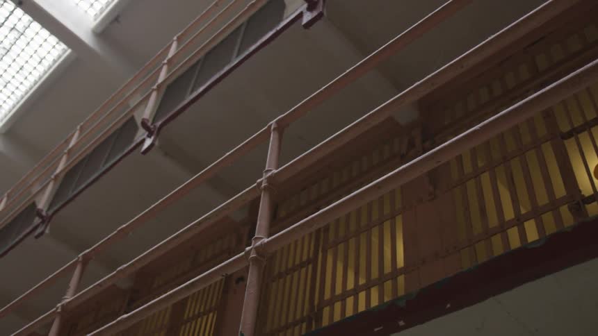 Inside of a prison with natural light coming in from the roof
